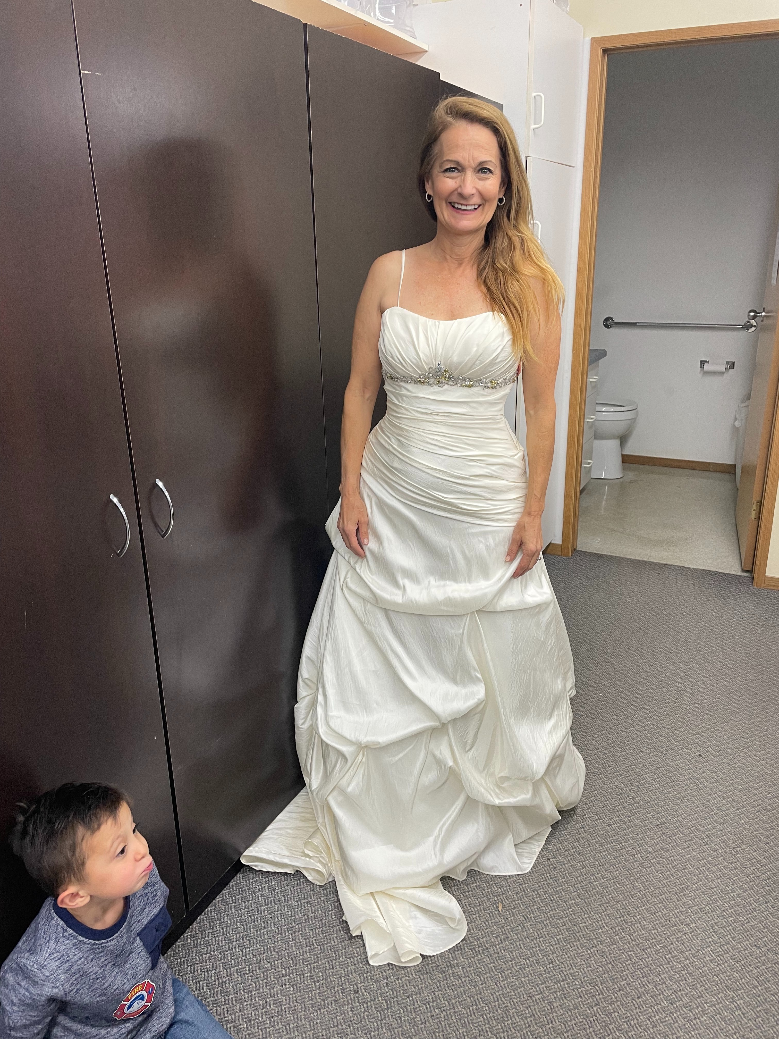 Grace Marcy Bayles trying on her wedding dress in the Warman MCC Thrift Shop in Saskatchewan.