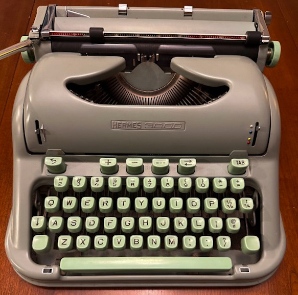 Overhead view of a vintage Hermes typewriter.