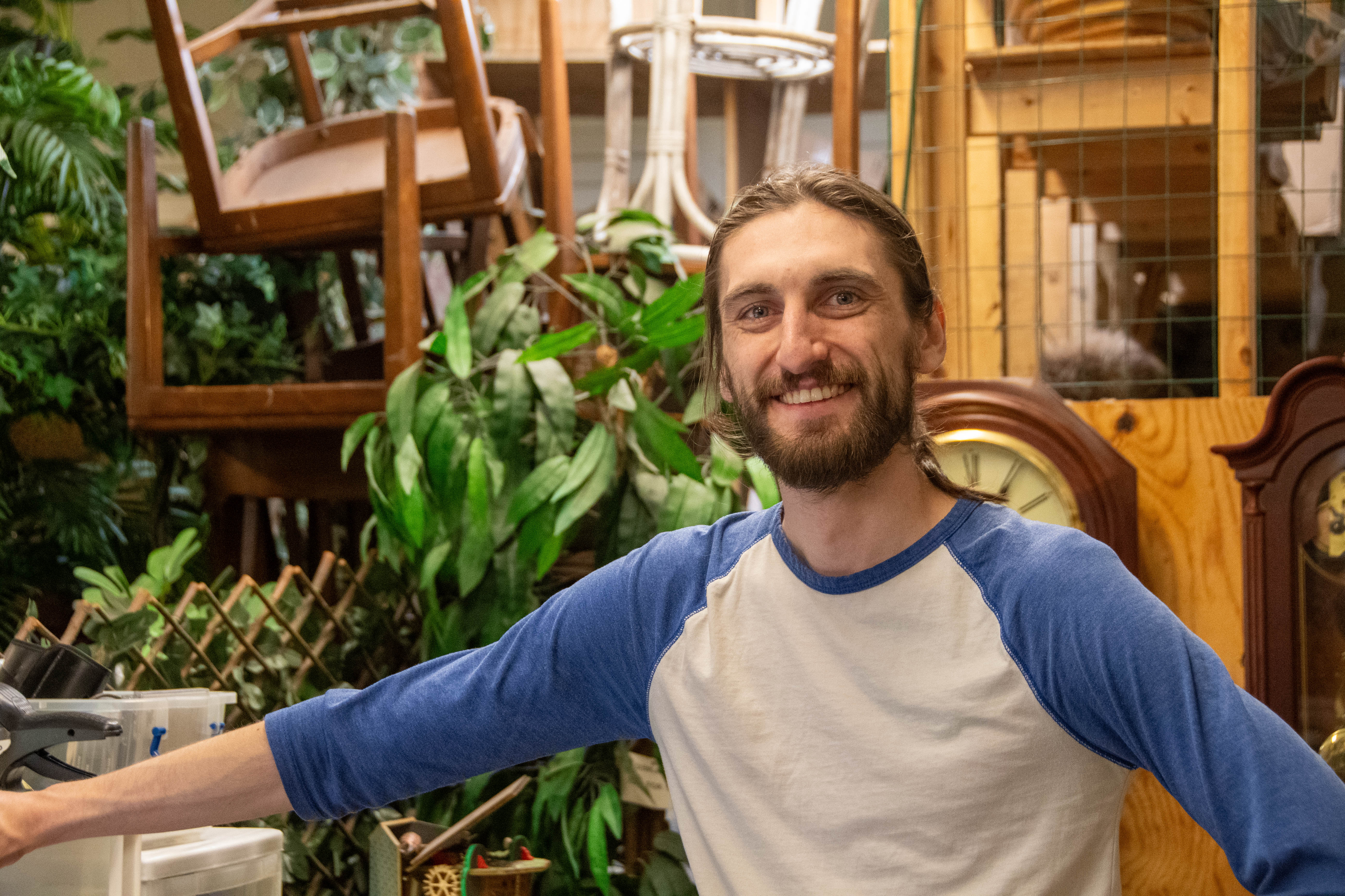 Volunteer Leo standing backroom in a thrift shop.