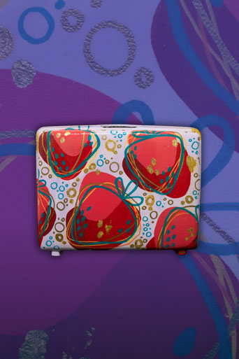 Strawberry Vacation by Amy Darkes. A fresh take on a print the artist has been reworking since 2022, now featured on a suitcase. 