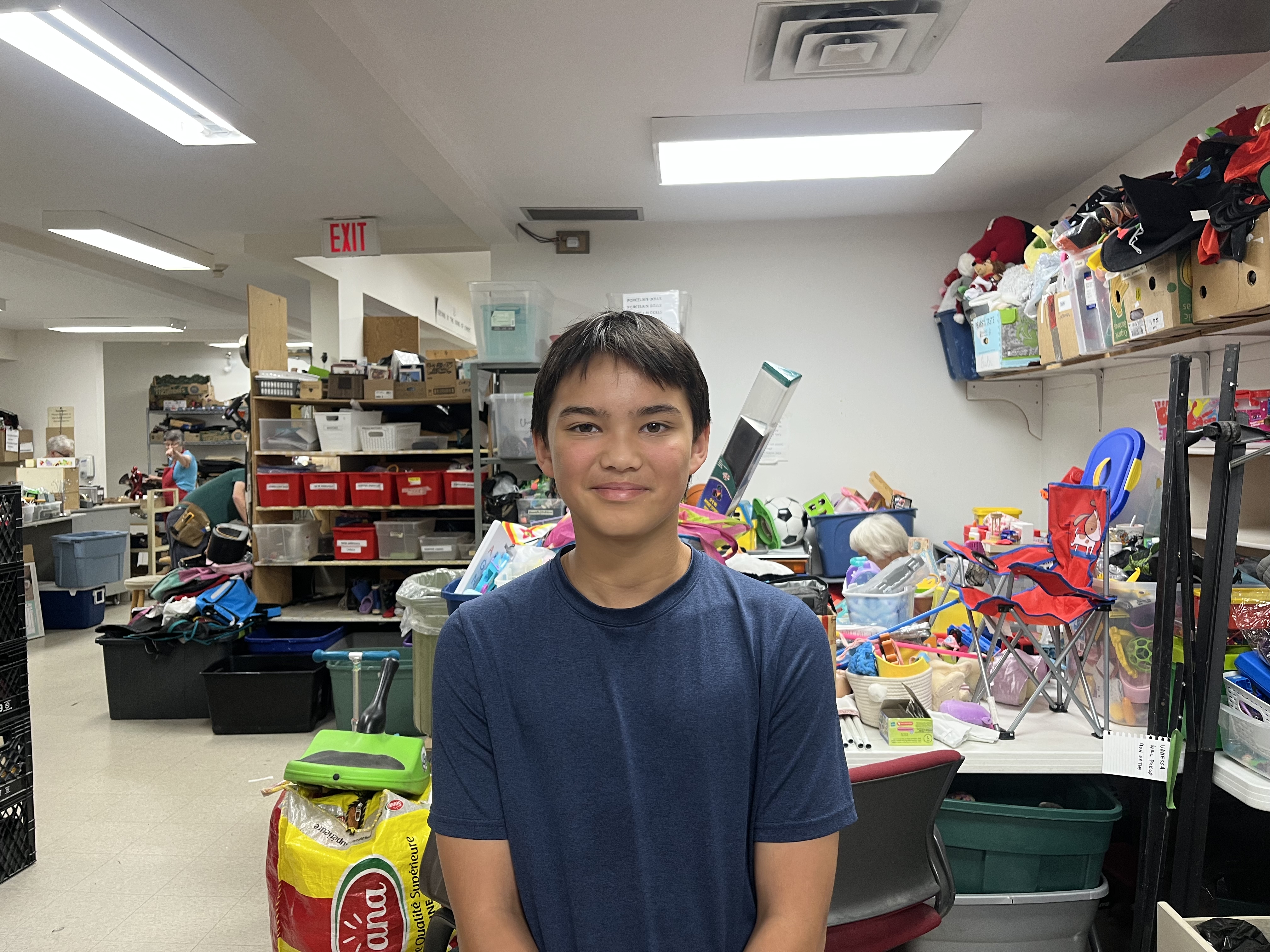 Max sitting in the backroom of a thrift store
