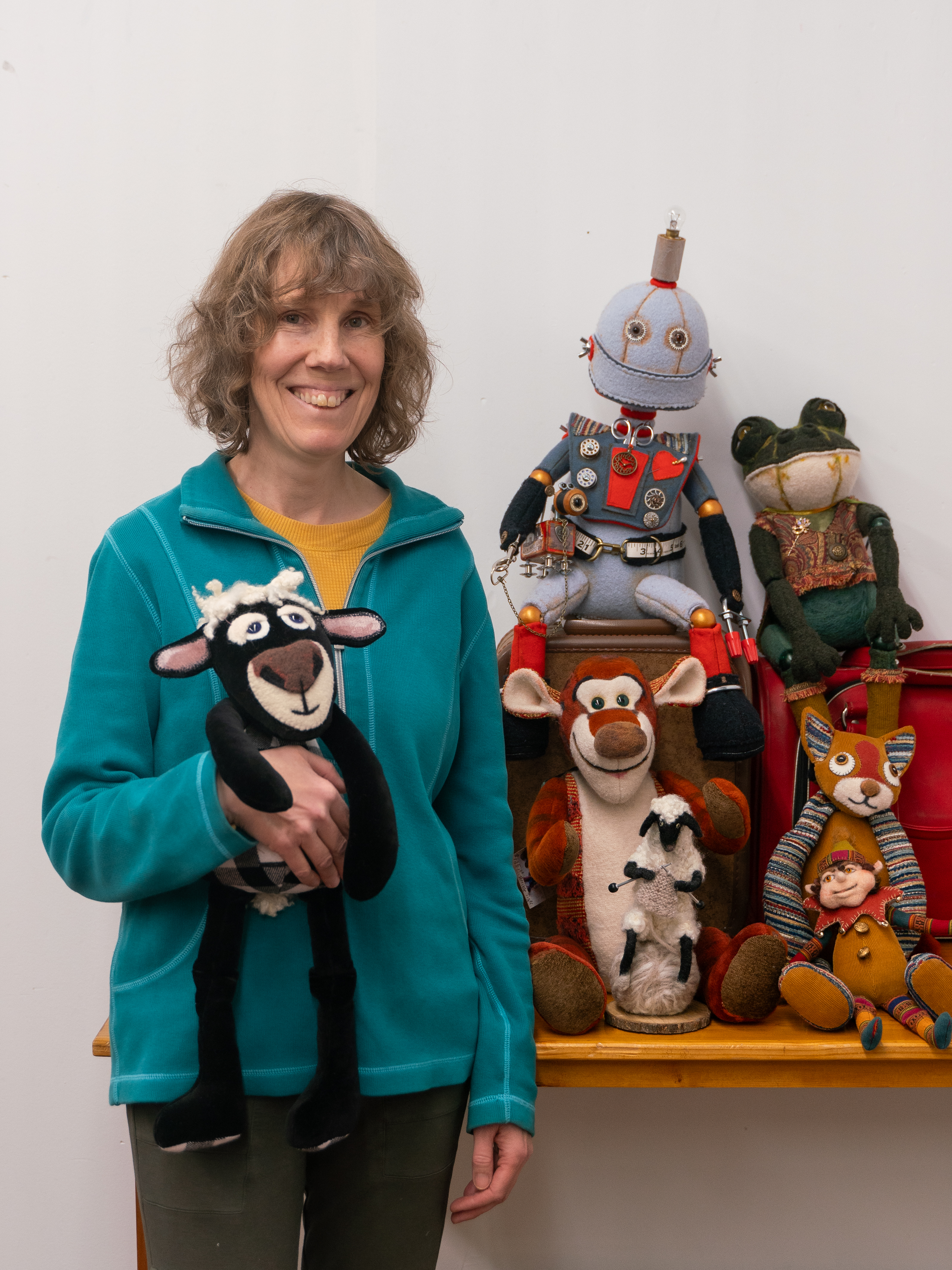 Chalise Kemp stands next to a collection of her soft sculptures.