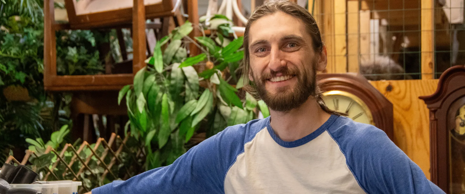Volunteer Leo standing backroom in a thrift shop.