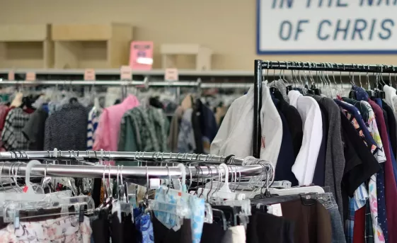 Clothes hanging on racks in the Winkler MCC Thrift shop.
