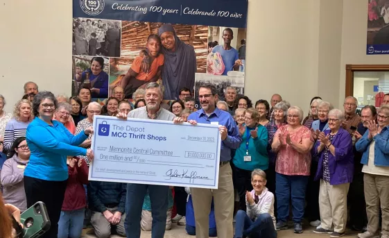 Staff and volunteers at The Depot thrift shop presenting a $1 million check.