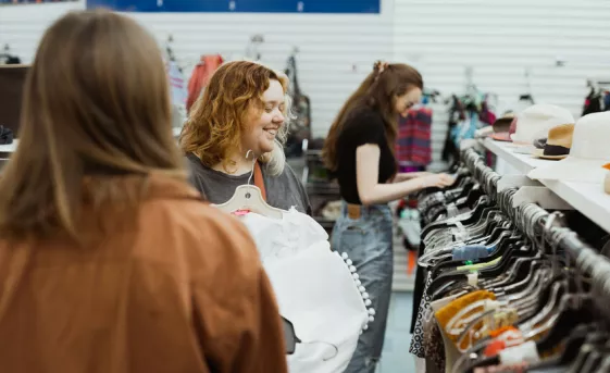 Katrina Funk and Lauren Balzer shop in the clothing department at the MCC Mission Thrift Shop.