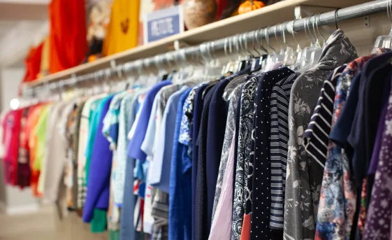 A rack of shirts sorted by color.