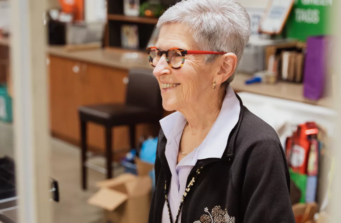 Volunteer working the cash desk at Centre Thrift.