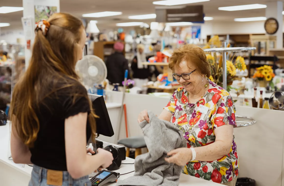 Volunteer working the cash register at the MCC Thrift Shop in Abbotsford, BC.