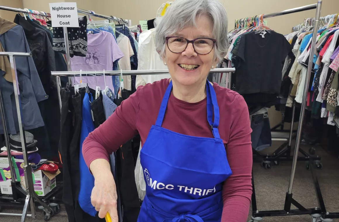 Volunteer Smiling while cutting rags