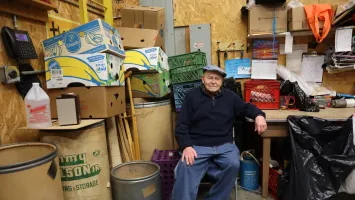 Nelson Hershey, longtime volunteer and founder of Columbia Re-Uzit Shop, sits in his favorite chair in the donation receiving area in the back of the MCC thrift shop.